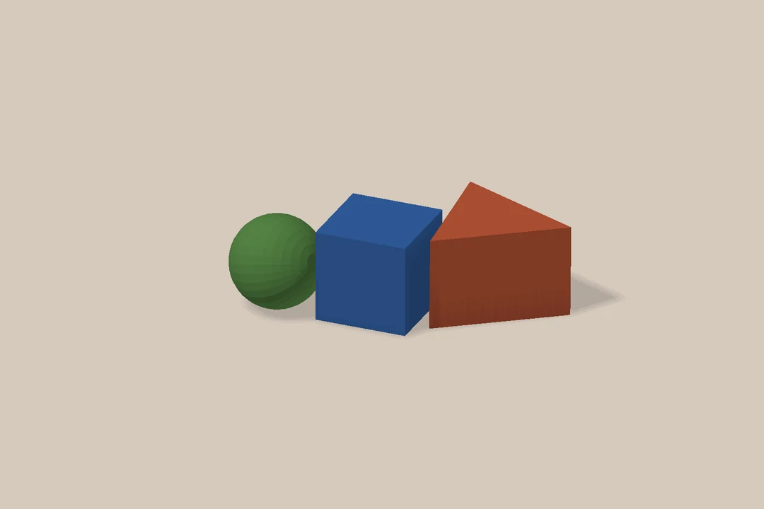 A ball, cube and triangular prism in the multi-object collision scene.